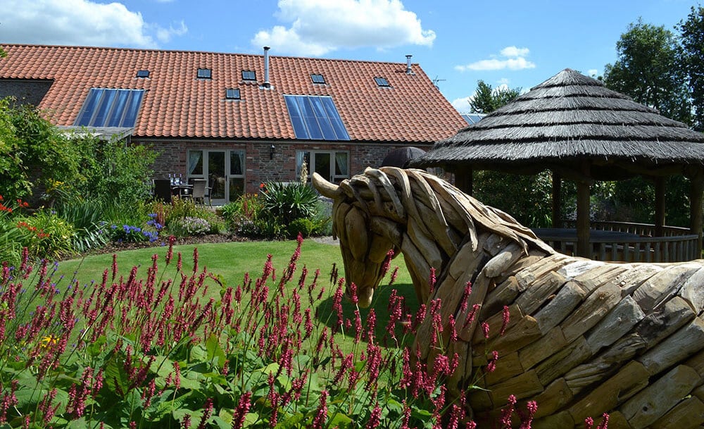 Luxury self-catering spa break: Henfield Barn's indoor swimming pool and horse sculpture