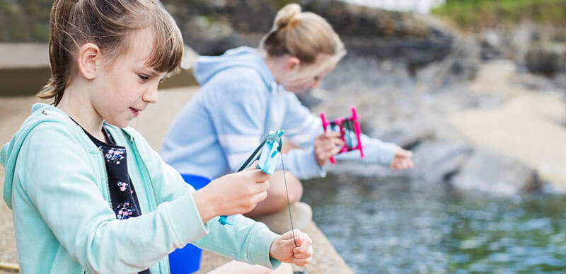 beach activities: crabbing from a harbour wall